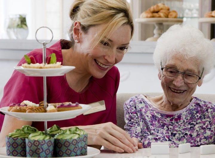 Smiling resident with member of staff at the Burlington Care Home